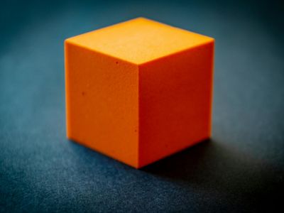 Symmetrical geometric pattern of cubes in dark blue environment